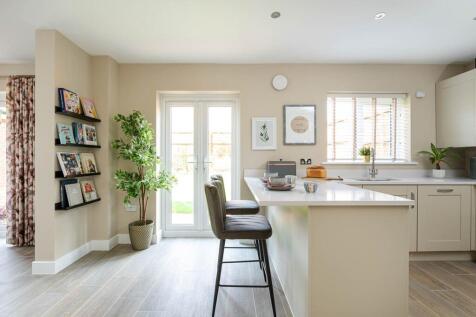 Step outside from the kitchen to the rear garden with French doors bringing the outside in