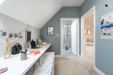 A desk and dressing table area maximise the space on the top floor landing