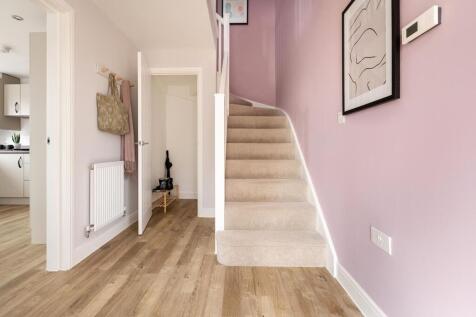 Central entrance hall has a convenient under stairs storage cupboard