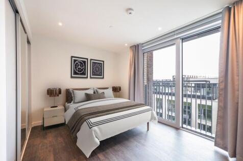 Relax in style with this modern bedroom boasting stunning urban views.
