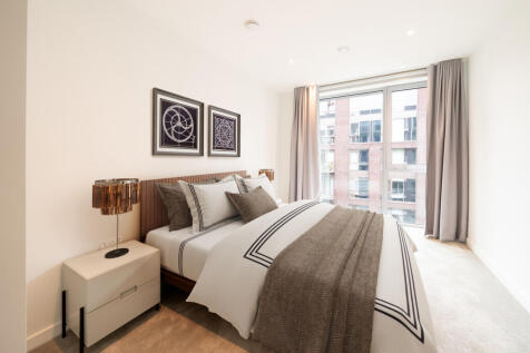Embrace comfort in this chic bedroom with stunning cityscape vistas.