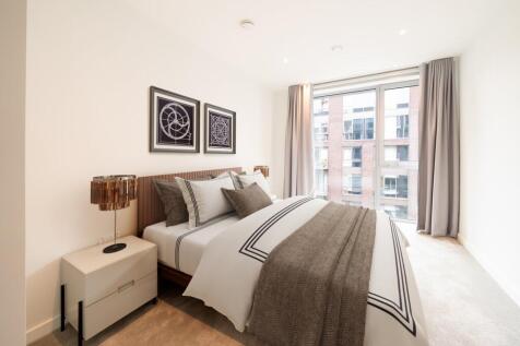 Embrace comfort in this chic bedroom with stunning cityscape vistas.