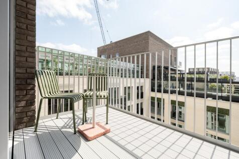 Experience urban tranquility from this stylish balcony, perfect for relaxation and admiring cityscapes.