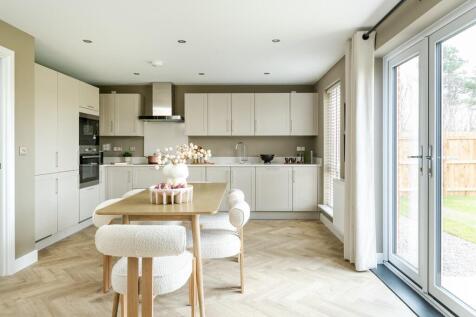 A modern kitchen and dining area with ample storage space