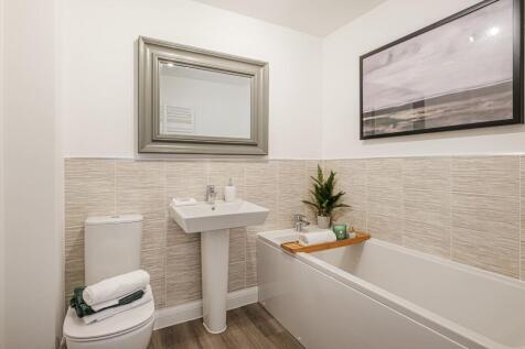 Hurst bathroom with half tiled walls