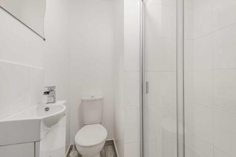 Bright, modern bathroom with a walk-in shower, ...