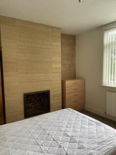 Bright, neutrally decorated double bedroom with...
