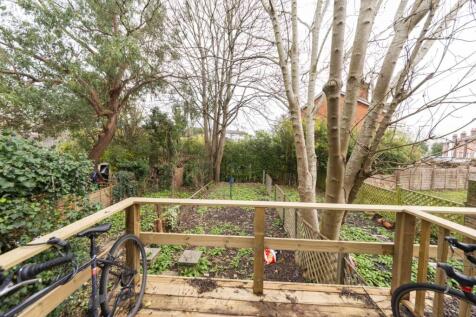 Private raised deck overlooking a leafy rear ga...