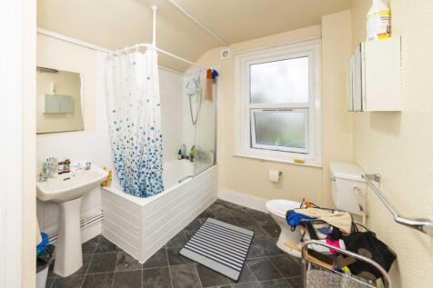 Bright, well-maintained bathroom with a shower-...