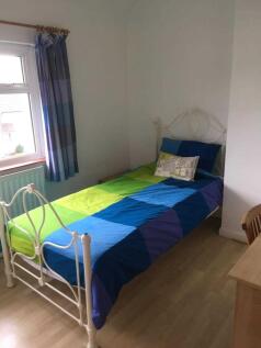 Bright, simply furnished single bedroom with a ...