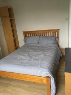 Bright, tidy double bedroom with wooden bed fra...