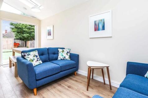 Bright, modern living room with comfortable blu...