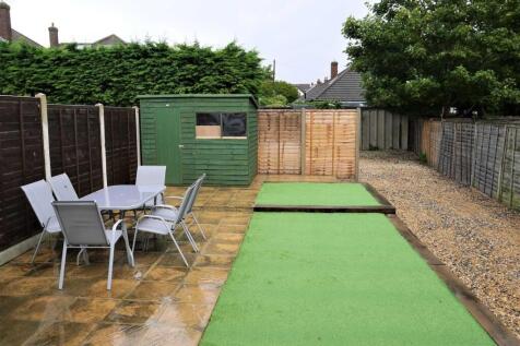 Well-maintained rear garden with a paved patio ...