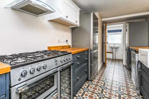 Bright, modern galley kitchen with a large free...