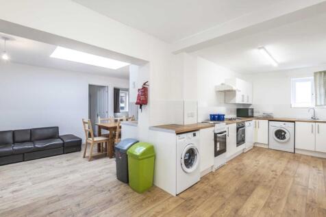Bright open-plan kitchen and living area with m...