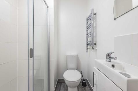 Bright modern bathroom with a walk-in shower, c...