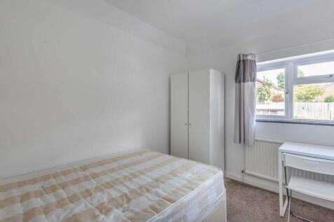 Bright, simply furnished double bedroom with a ...