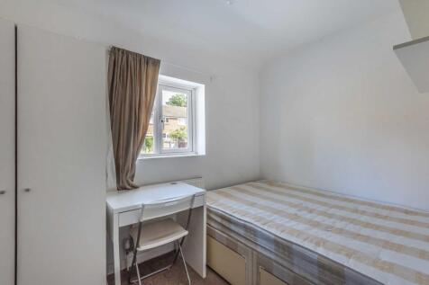 Bright, simply furnished bedroom with a window,...