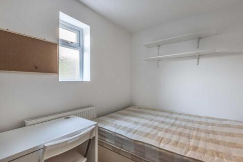 Bright, simply furnished bedroom with a single ...