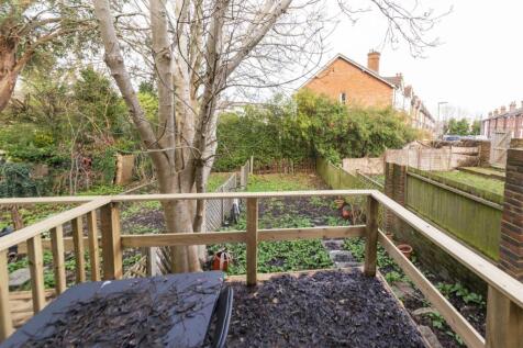 Private rear garden with a raised decking area ...