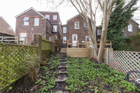 Rear exterior of a brick terraced house with a ...