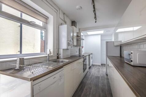 Bright galley kitchen with long worktops, integ...