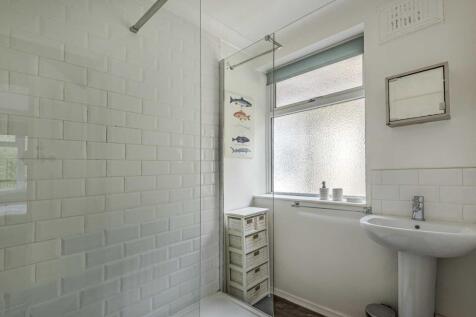 Bright, modern bathroom with a walk-in shower, ...
