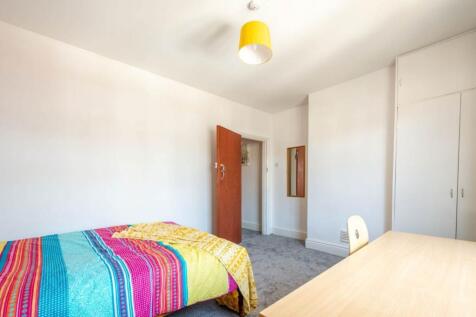 Bright, tidy bedroom with neutral walls, large ...