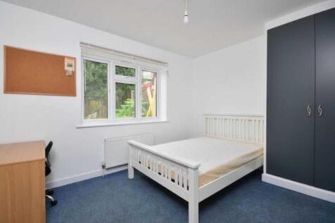 Bright, simply furnished bedroom with a double ...