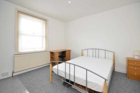 Bright, simply furnished bedroom with a double ...