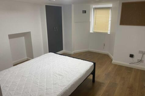 Bright, simply furnished double bedroom with a ...