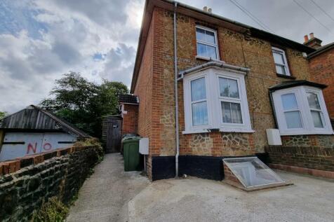 Brick-fronted semi-detached house with a bay wi...