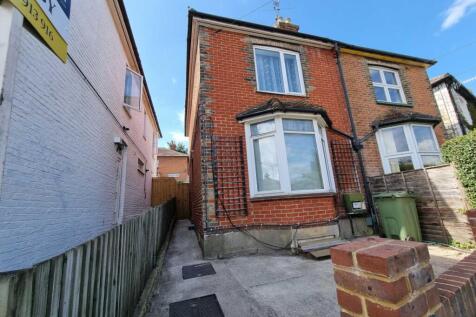 Brick-front semi-detached house with a bay wind...