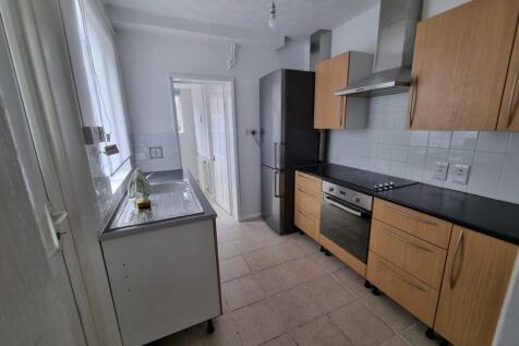 Bright galley kitchen with modern appliances, b...