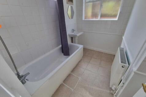 Bright, clean bathroom with a full-size bathtub...