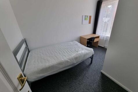 Neat single bedroom with a simple metal-framed ...