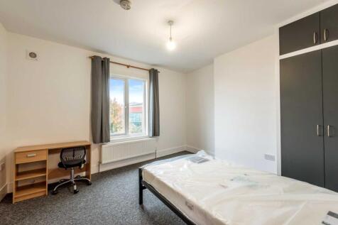 Bright, simply furnished double bedroom with a ...