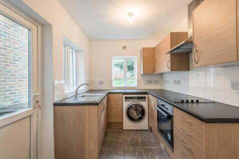 Bright modern kitchen with wood-effect cabinetr...
