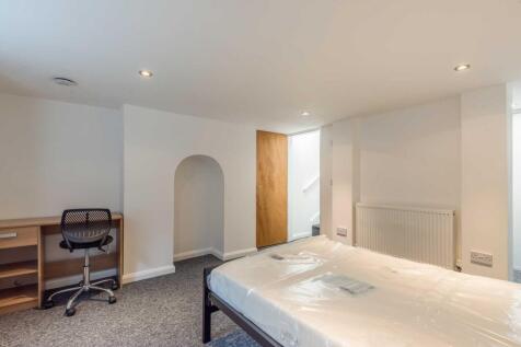 Bright, neutrally decorated bedroom with a doub...