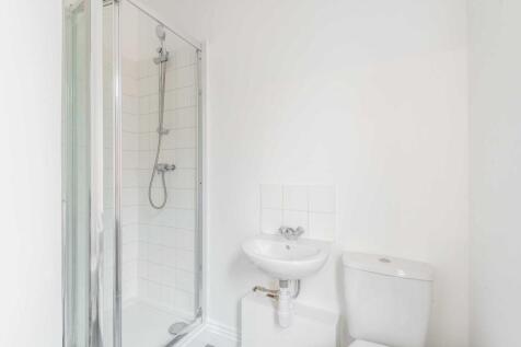 Bright, modern bathroom with a walk-in shower, ...