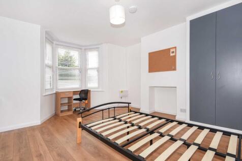 Bright, modern bedroom with wood-effect floorin...