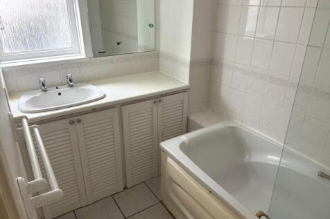 Bright, well-kept bathroom with a fitted vanity...