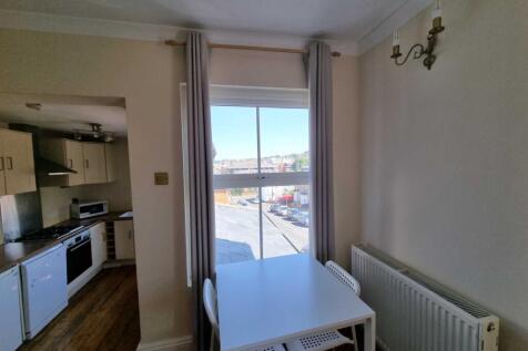 Bright eat-in kitchen with a dine-in table by a...