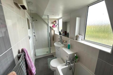 Bright modern bathroom with a large window, wal...