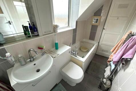 Bright compact bathroom with a modern sink and ...