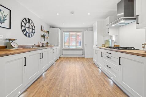 The galley kitchen has ample storage and worktop space