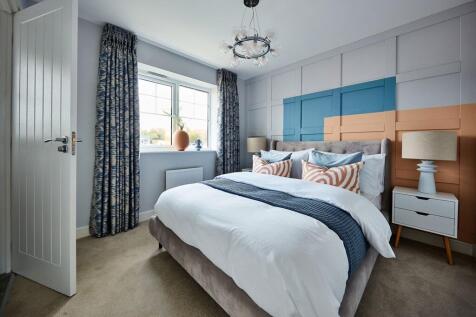 Large windows flood the bedroom with light