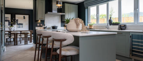 Redrow internal stylish kitchen with large island and barstools with separate dining room