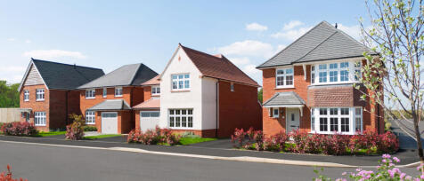 Modern residential houses with red brick and white finishes, set on a sunny day with neatly maintain