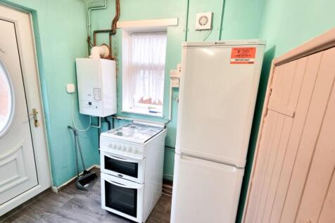 6 Utility Room, with Storage Cupboard Leading to B